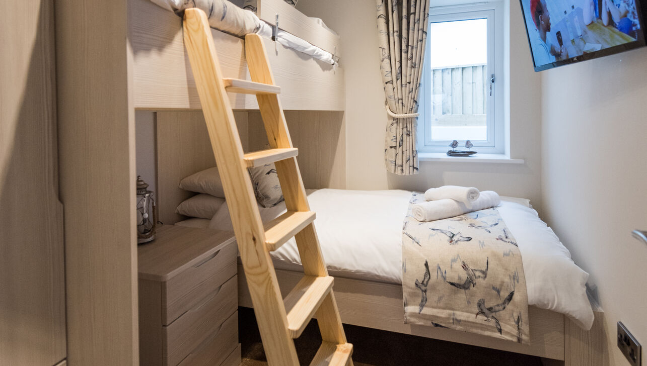 double bed and above bunk bed at driftwood holiday apartment