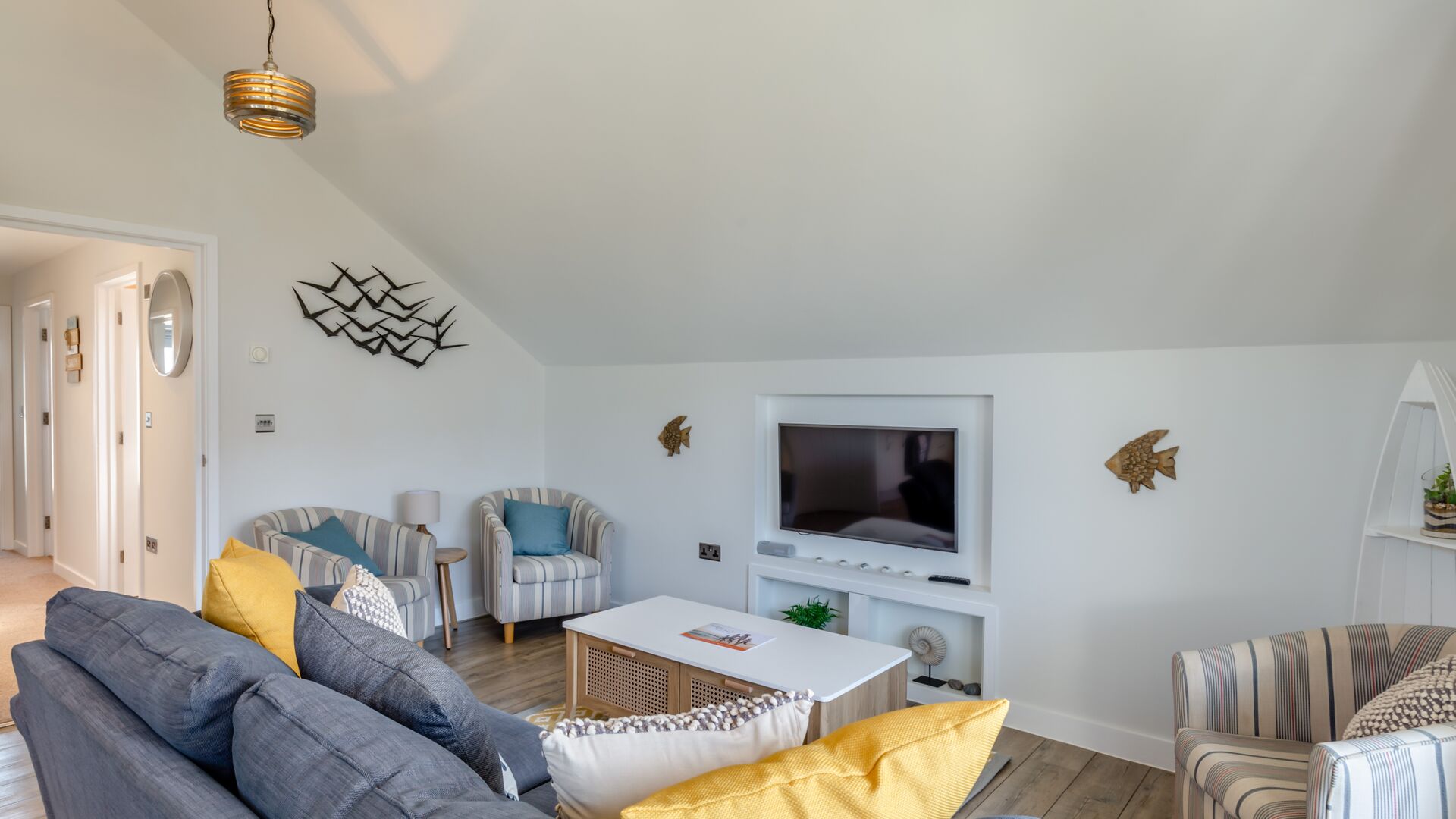 comfy sofas and the tv in the Beachcomber apartment